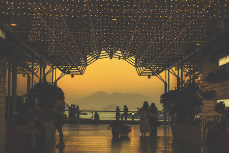 amber toned interior shows visitors seated along a corridor, Tsim Sha Tsui Nov 16 2025のeditorial素材