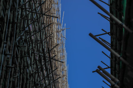 Bamboo scaffolding against a clear blue sky highlights traditional construction Sept 14 2025のeditorial素材