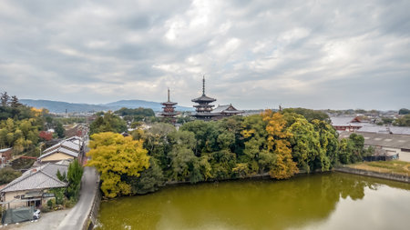 A serene autumn scene featuring traditional Japanese pagodas Nov 27 2025の写真素材
