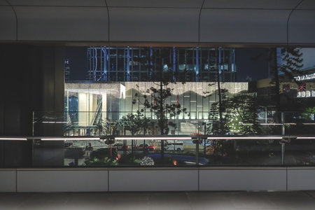 Urban nighttime streetscape featuring illuminated Chater Road architecture