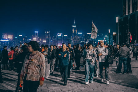 Tourist enjoying panoramic view of Victoria Harbour promenade