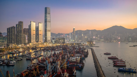 Scenic sunset over Victoria Harbor from Yau Ma Tei Pier Dec 24 2025