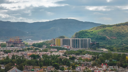 Modern housing estate contrasting with traditional village scenery Dec 20 2025のeditorial素材