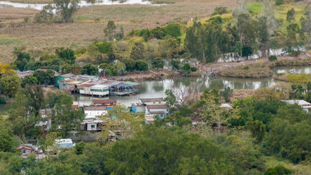 view of a riverside community of colorful, weathered stilt houses b Dec 20 2025のeditorial素材