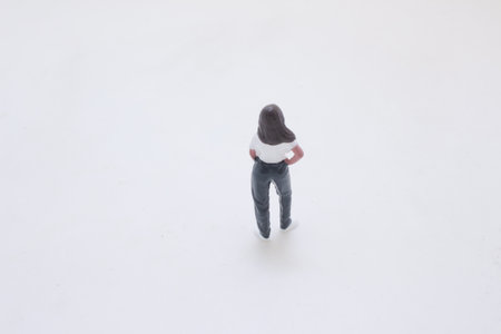 A small plastic figurine of a woman in a white tee and jeans,の写真素材
