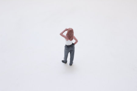 A small figurine of a woman in a white tank top and jeans standsの写真素材