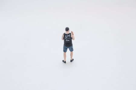 A small male figurine posed in a fighting stance, wearing a tankの写真素材