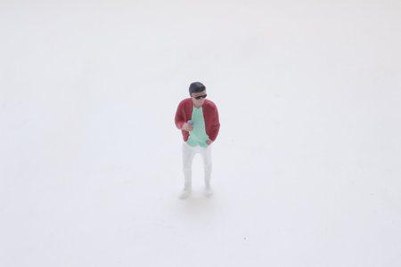 A tiny figurine of a stylish man wearing a red jacket, mint green sの写真素材