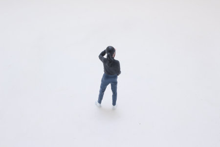 A tiny toy figure dressed in a black jacket, blue jeansの写真素材