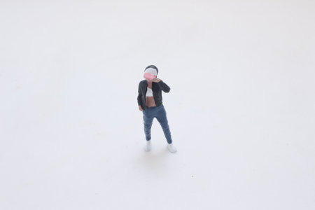 A tiny toy figure dressed in a black jacket, blue jeansの写真素材