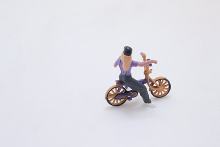 A small plastic figurine of a person riding a purple motorcycleの写真素材
