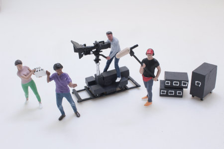 playful diorama of tiny figures making a movie: a cameraman on a dolly, aの写真素材