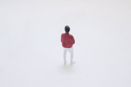 A tiny figurine of a stylish man wearing a red jacket, mint green sの写真素材