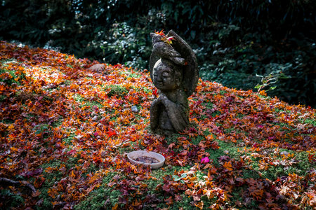 Serene Stone Statue Surrounded by Vibrant Autumn Maple Leaves Nov 23 2025