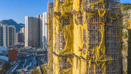 covers a high rise facade, with yellow tarps fluttering Jan 11 2026