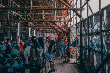 Large festival audience gathers beneath ornate lanterns and bamboo scaffolding Jan 17 2026