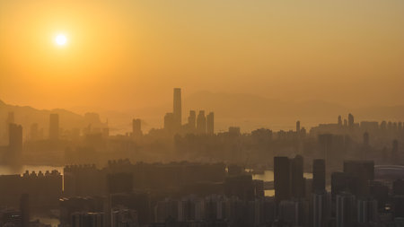 Bright evening sun casts warm glow across Kowloon skyline Jan 18 2026のeditorial素材