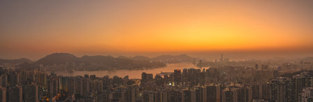 glowing sky highlights Hong Kong buildings and distant mountains Jan 18 2026