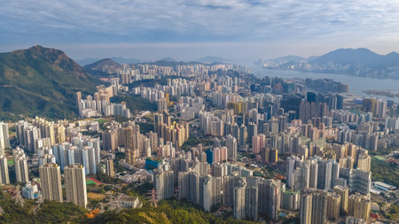 Dense residential towers contrast strongly with surrounding mountain greenery Jan 25 2026のeditorial素材