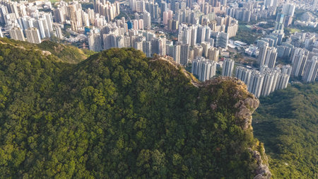 Mountain ridge overlooks tightly packed residential towers below Jan 25 2026のeditorial素材