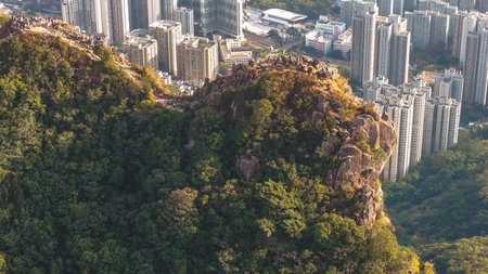 Steep rocky ridge towers over packed urban skyline Jan 25 2026のeditorial素材