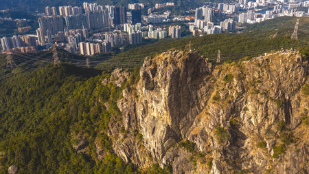Mountain ridge trail overlooks tightly clustered Kowloon apartment skyline Jan 25 2026のeditorial素材