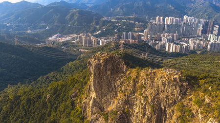 Mountain ridge overlooks packed urban skyline of Kowloon Jan 25 2026のeditorial素材