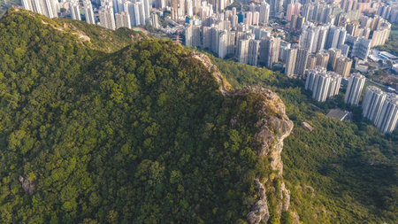 Mountain ridge overlooks tightly packed residential towers below Jan 25 2026のeditorial素材