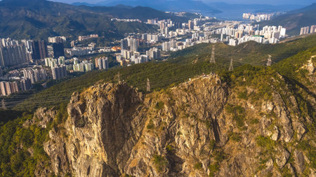 Mountain ridge trail overlooks tightly clustered Kowloon apartment skyline Jan 25 2026のeditorial素材