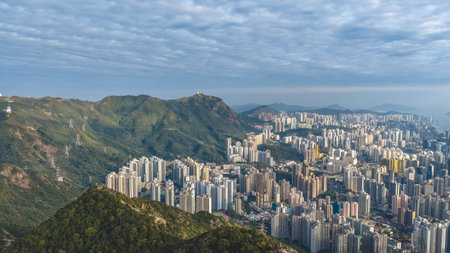 Dense residential towers contrast strongly with surrounding mountain greenery Jan 25 2026のeditorial素材