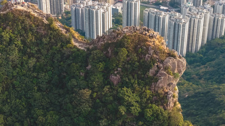Mountain ridge overlooks tightly packed residential towers below Jan 25 2026のeditorial素材