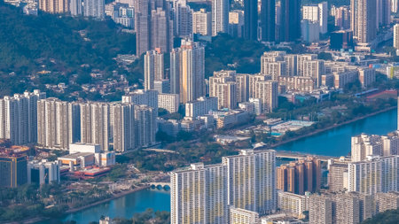 Urban skyline stretches across valley beneath surrounding green mountains Jan 25 2026のeditorial素材
