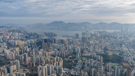 Dense residential towers contrast strongly with surrounding mountain greenery Jan 25 2026のeditorial素材