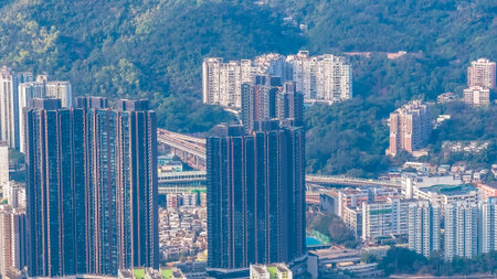 Dense residential towers contrast sharply with surrounding green mountains Jan 25 2026