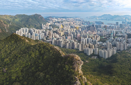 Mountain ridge overlooks tightly packed residential towers below Jan 25 2026