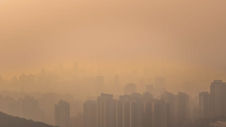Golden evening haze softens dense cityscape silhouettes Jan 24 2026