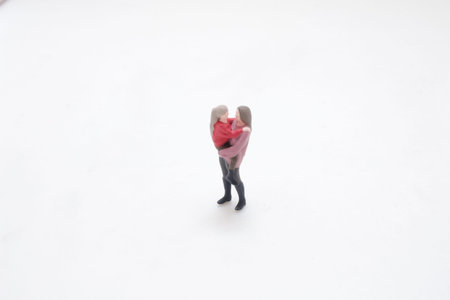 Tiny figurine pair depicts family bonding in simple scene