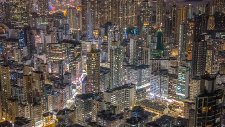 Dense illuminated towers rise above bustling nighttime district Feb 6 2026