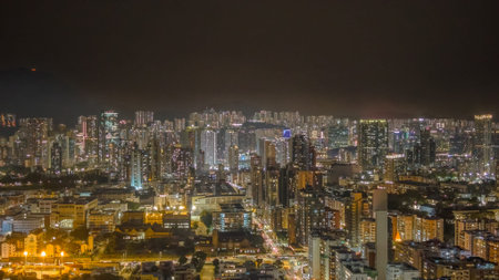 Illuminated towers rise over bustling streets in Kowloon Feb 6 2026のeditorial素材