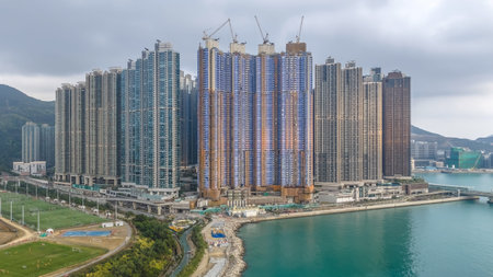 Massive residential clusters rise beside sea under overcast sky Feb 7 2026