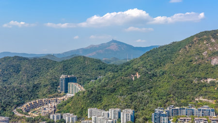 Green forested terrain surrounds luxury housing and valley views Feb 11 2026のeditorial素材