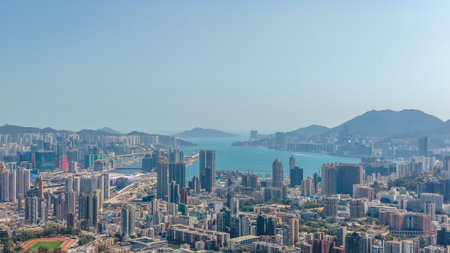 High rise clusters overlook blue harbour waters under clear sky Feb 11 2026のeditorial素材