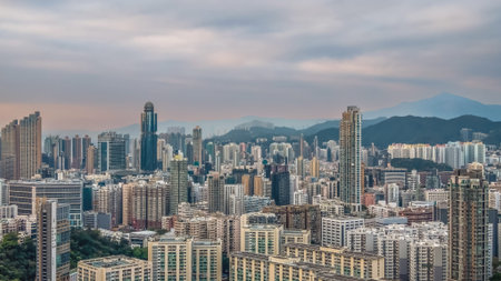 Clear hazy sky highlights Mong Kok buildings and mountain backdrop Feb 1 2026のeditorial素材