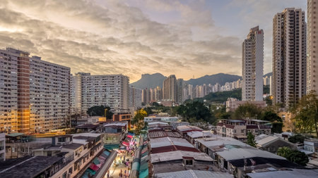 Historic village rooftops contrast modern towers at sunset Feb 5 2026のeditorial素材