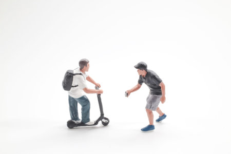 Tiny figurines interact while posing on clean bright backgroundの写真素材