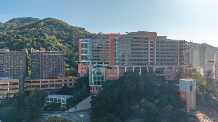 Contemporary academic buildings extend across elevated green university grounds Feb 14 2026のeditorial素材