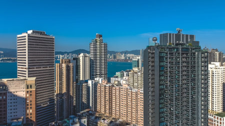 Sunlit high rise towers rise above bright harbour panorama Feb 14 2026のeditorial素材
