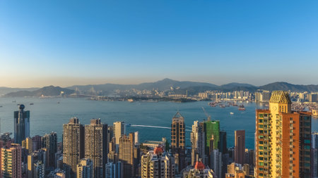 Harbourfront park and towers shine brightly beside calm waters Feb 14 2026のeditorial素材