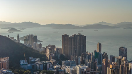 Harbourfront park and towers shine brightly beside calm waters Feb 14 2026のeditorial素材