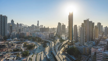 Curving highways lead through dense high rise district toward mountains Feb 15 2026